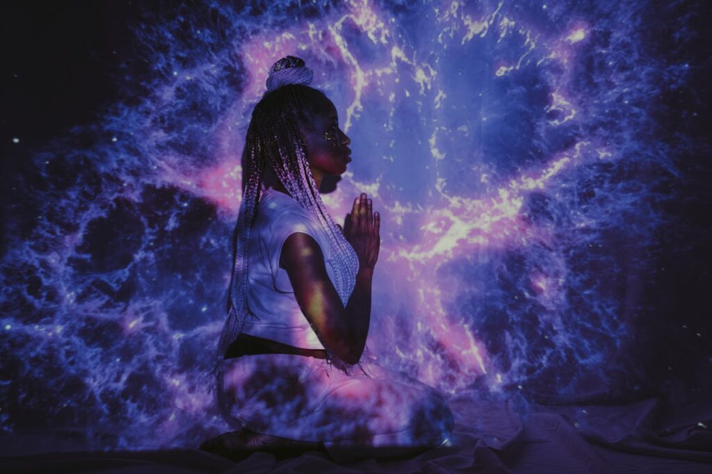 Crafting Captivating Headlines: Your awesome post title goes here A woman kneels in a galaxy projection, creating a mesmerizing cosmic backdrop.